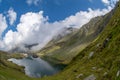 Balea lake and Balea Hotel in spring time with clouds Royalty Free Stock Photo